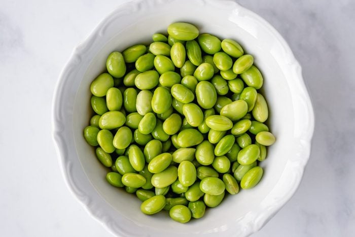 Overhead view of a bowl of shelled edamame beans