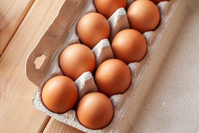 A few brown eggs among the empty cells of a large cardboard bag