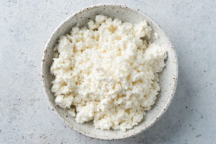 Cottage cheese or curd cheese crumbs in a bowl